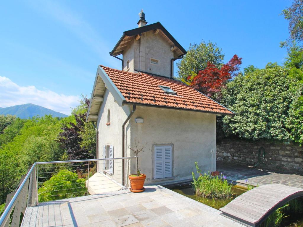 eine kleine weiße Kirche mit einem Kirchturm auf dem Deck in der Unterkunft Holiday Home Il Roccolo by Interhome in Pettenasco