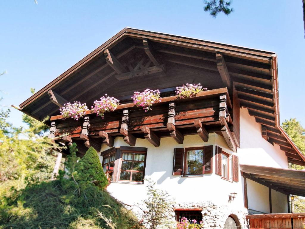 a house with flowers on the top of it at Holiday Home Solea - IST201 by Interhome in Imst