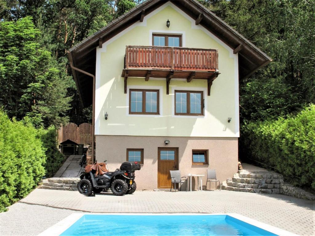 a motorcycle parked in front of a house at Holiday Home Jaroslav - DEH130 by Interhome in Dehtáře