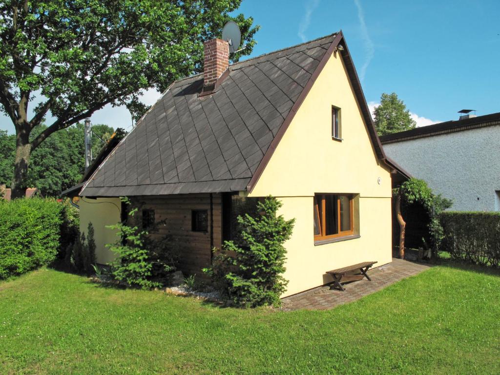 a small yellow house with a black roof at Chalet Jiri - DEH110 by Interhome in Žabovřesky