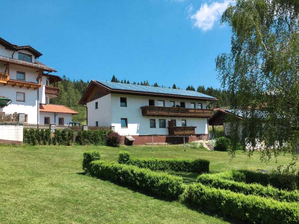 a large white house with a green yard at Apartment Irene by Interhome in Lohberg