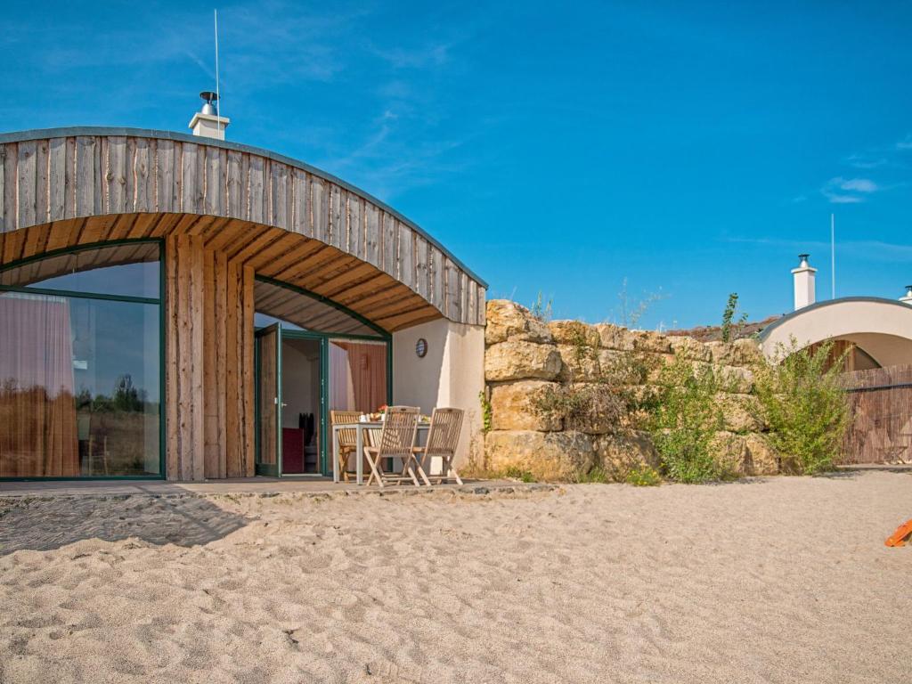 a house on the beach with a patio at Holiday Home Dünenhaus Familia Comfort by Interhome in Großpösna