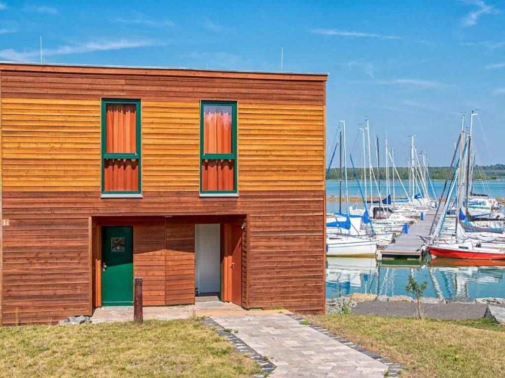 a wooden building with boats in a marina at Holiday Home Hafenhaus by Interhome in Großpösna