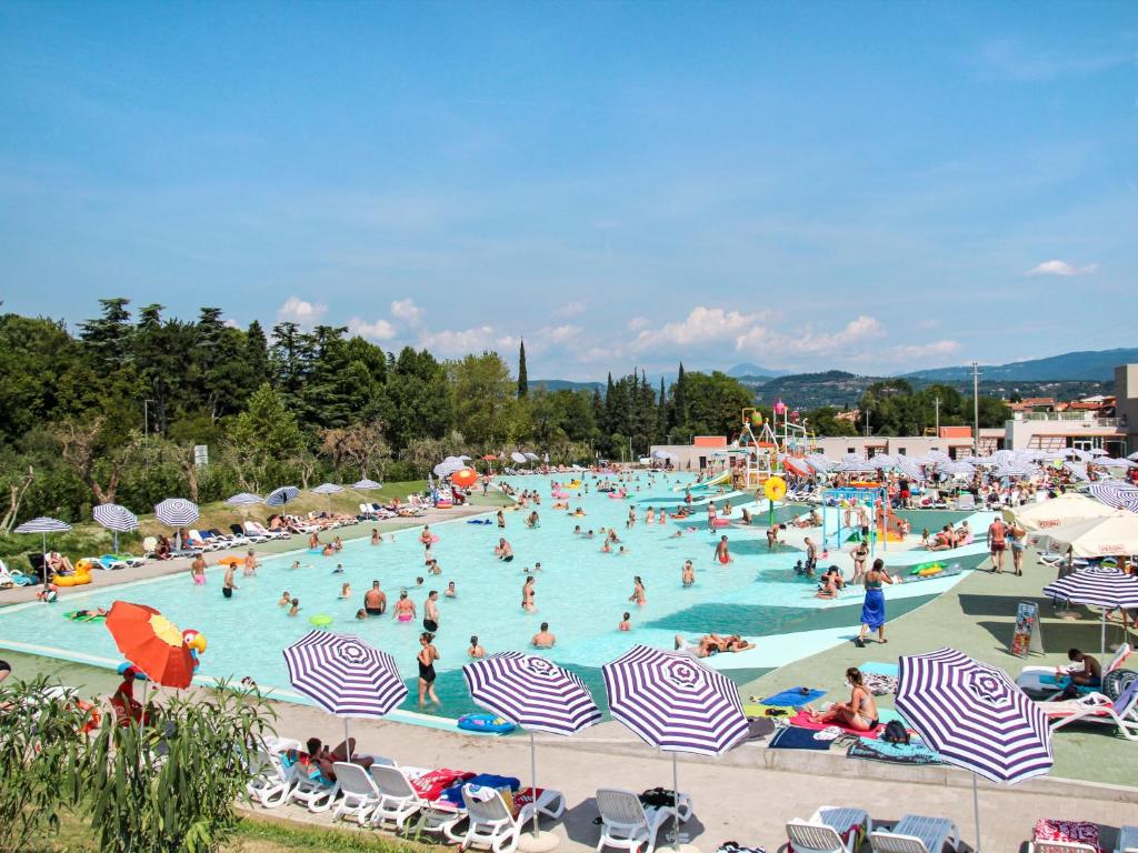 a group of people in a pool at a resort at Holiday Home Cisano & San Vito-1 by Interhome in Lazise