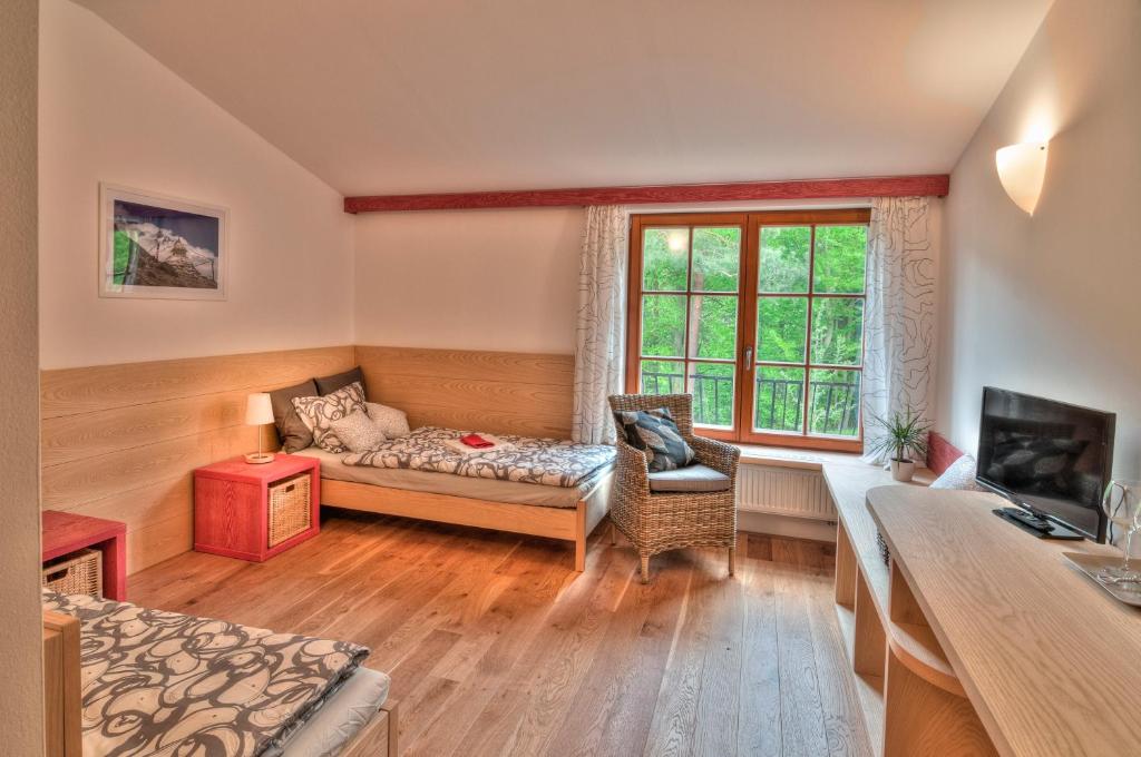 a living room with a couch and a window at Statek Samsara in Blansko