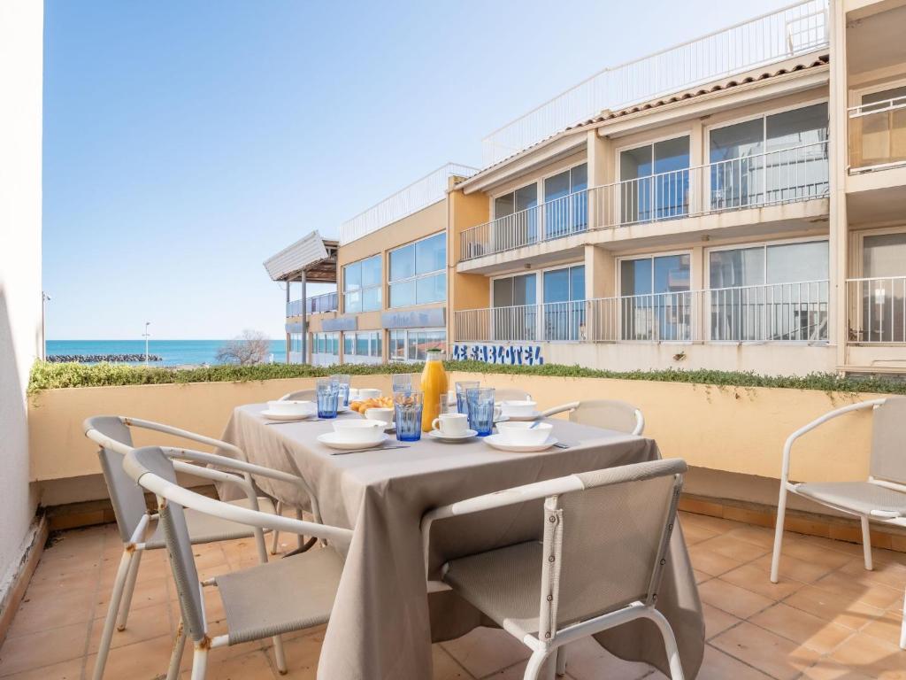 a table and chairs on the balcony of a building at Apartment Le Capri-1 by Interhome in Cap d'Agde