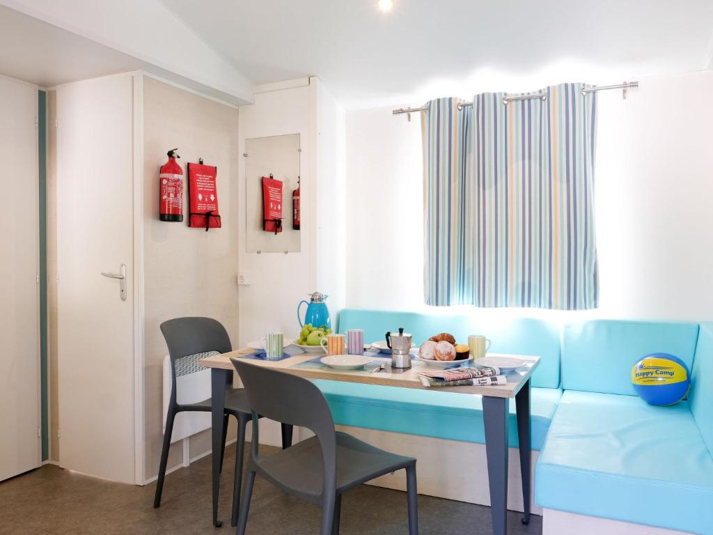 jadalnia z niebieskim stołem i krzesłami w obiekcie Holiday Home Camping Butterfly-2 by Interhome w mieście Peschiera del Garda