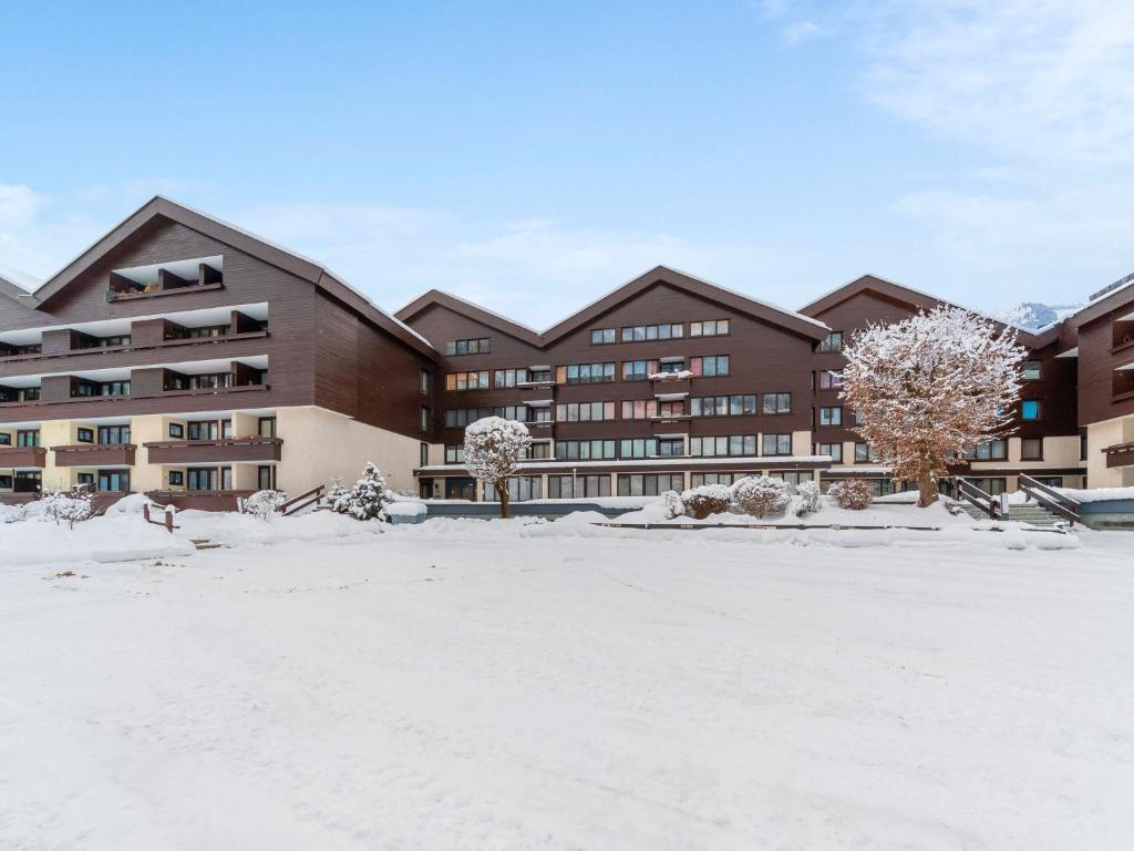 a large building with snow in front of it at Apartment Plathner by Interhome in Bad Hofgastein