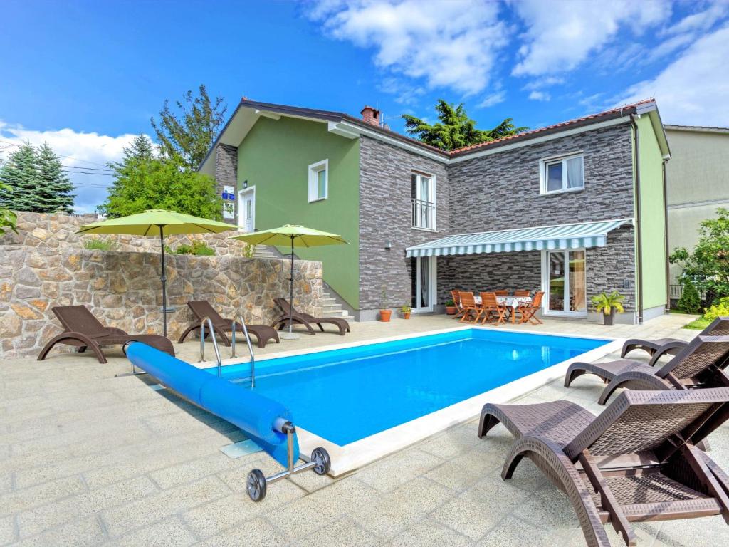 a swimming pool in front of a house at Holiday Home Dante by Interhome in Marčelji