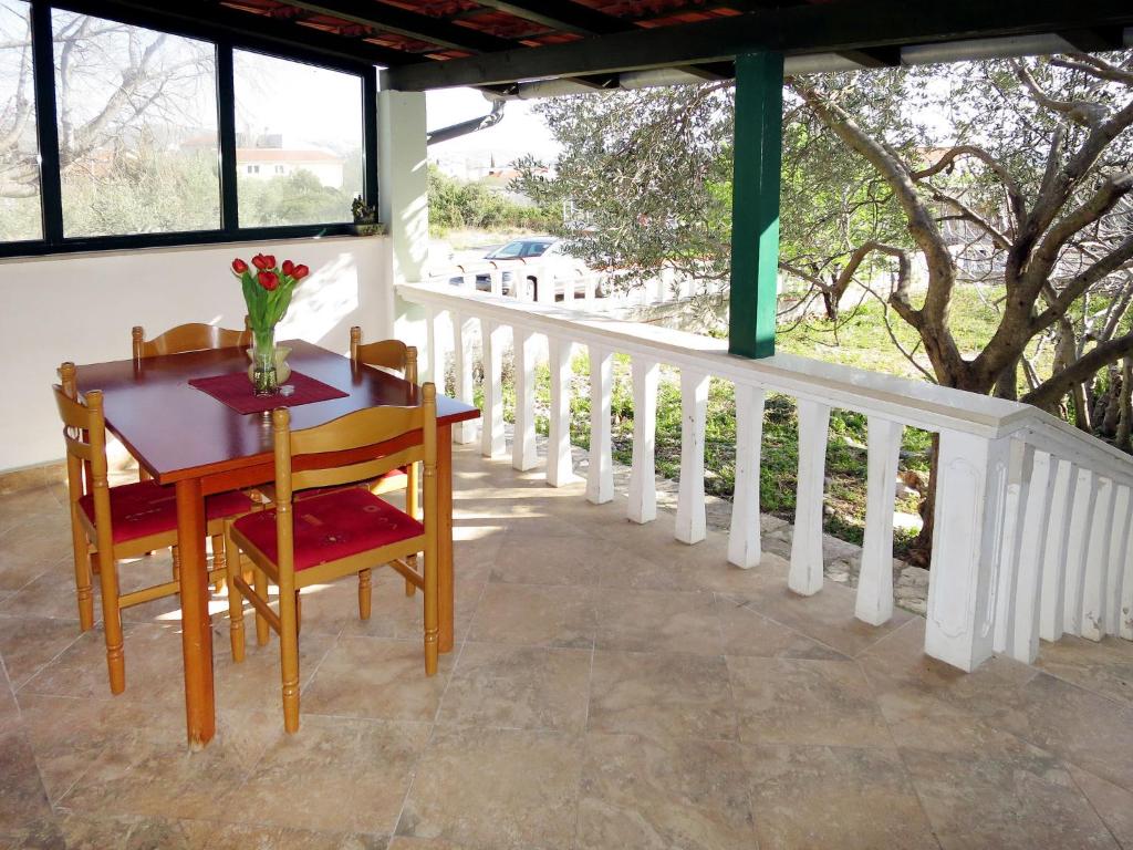 a table and chairs on the porch of a house at Holiday Home Camp Marko - ROZ335 by Interhome in Zečevo