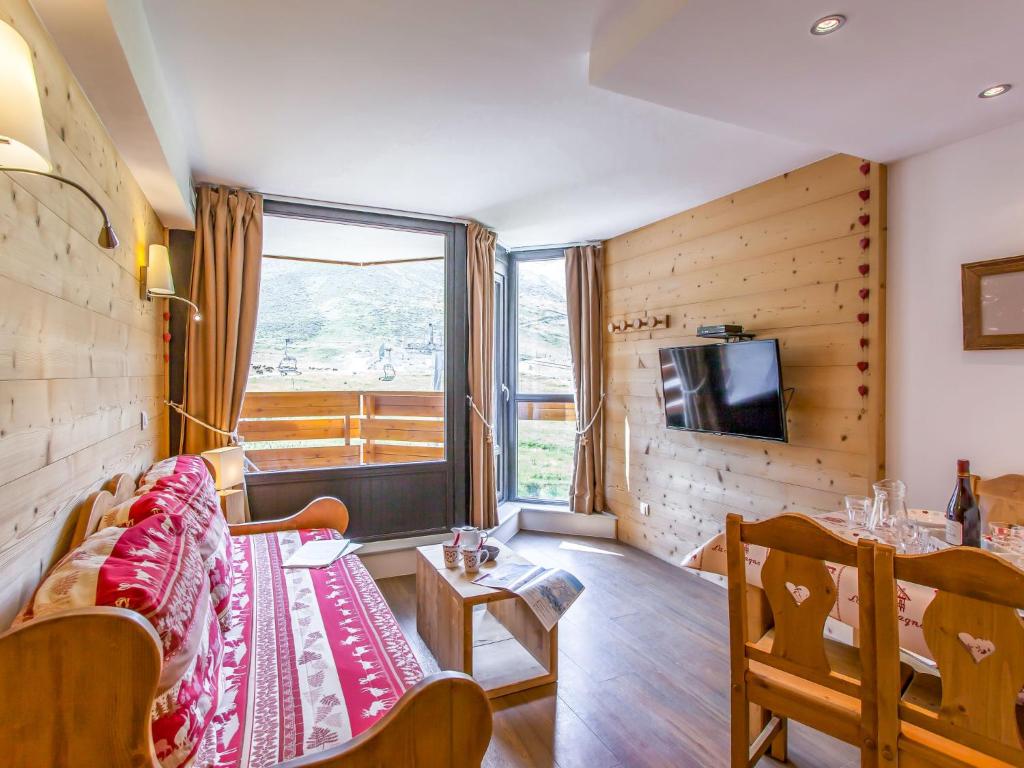 a living room with a couch and a tv at Studio Le Borsat - Val Claret-14 by Interhome in Tignes