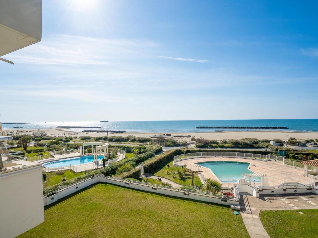 a view of the beach from the balcony of a building at Apartment Le Sunset-Cap Sud-20 by Interhome in Cap d'Agde