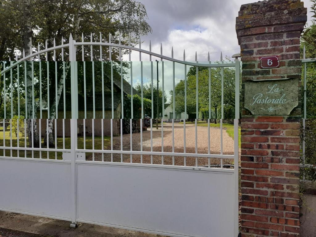 a gate in front of a park with a fence at La PASTORALE in La Puisaye