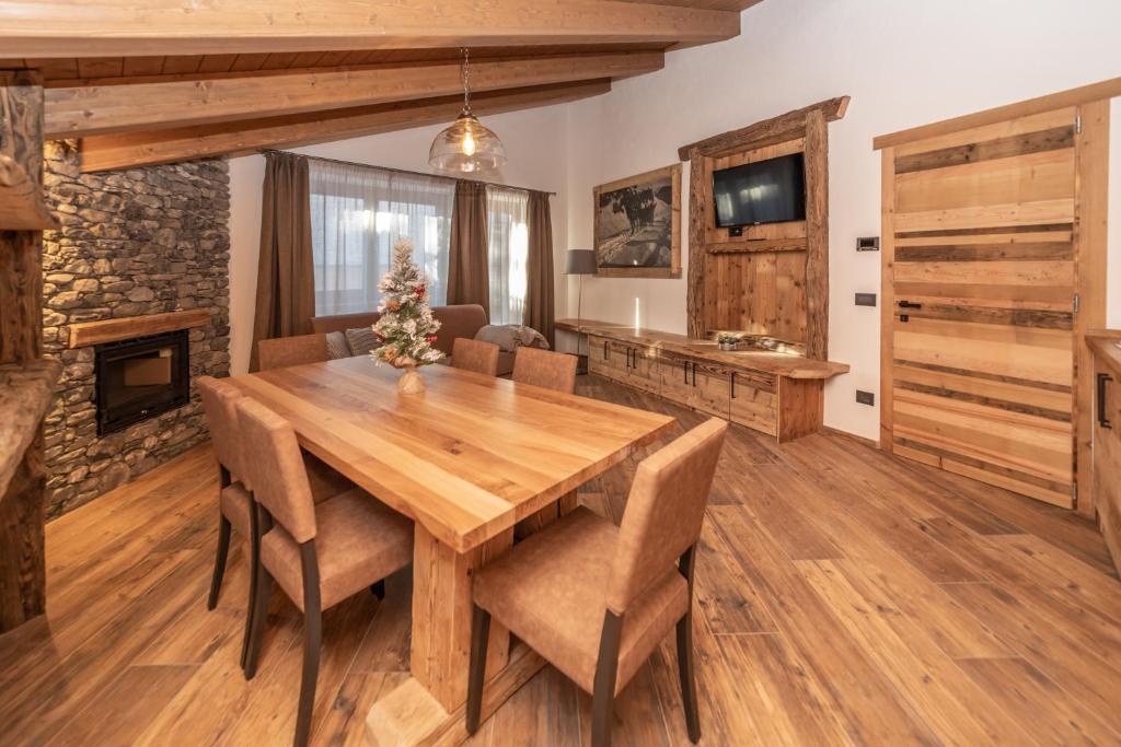 a kitchen with wooden floors and a wooden table at Appartamenti ABC Group in Sauze dʼOulx