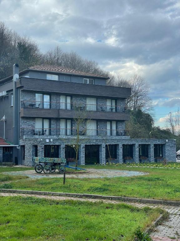 a large building with a bench in front of it at Adess Otel in Çekme