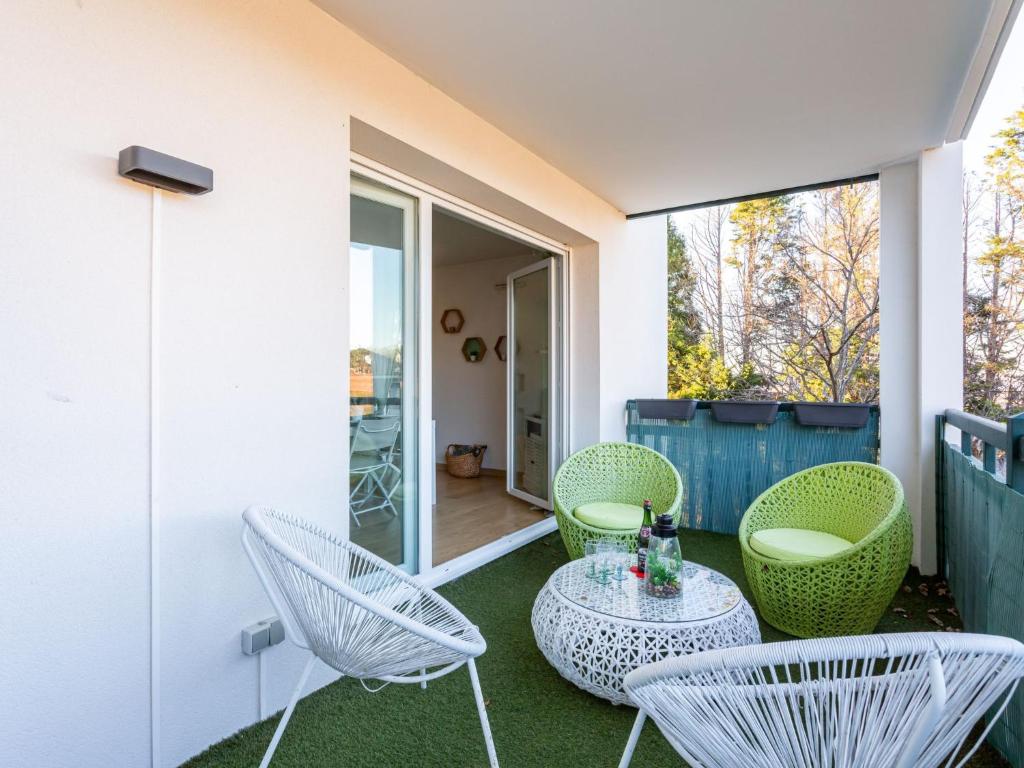 a patio with chairs and a table on a balcony at Apartment IBIRY by Interhome in Ciboure