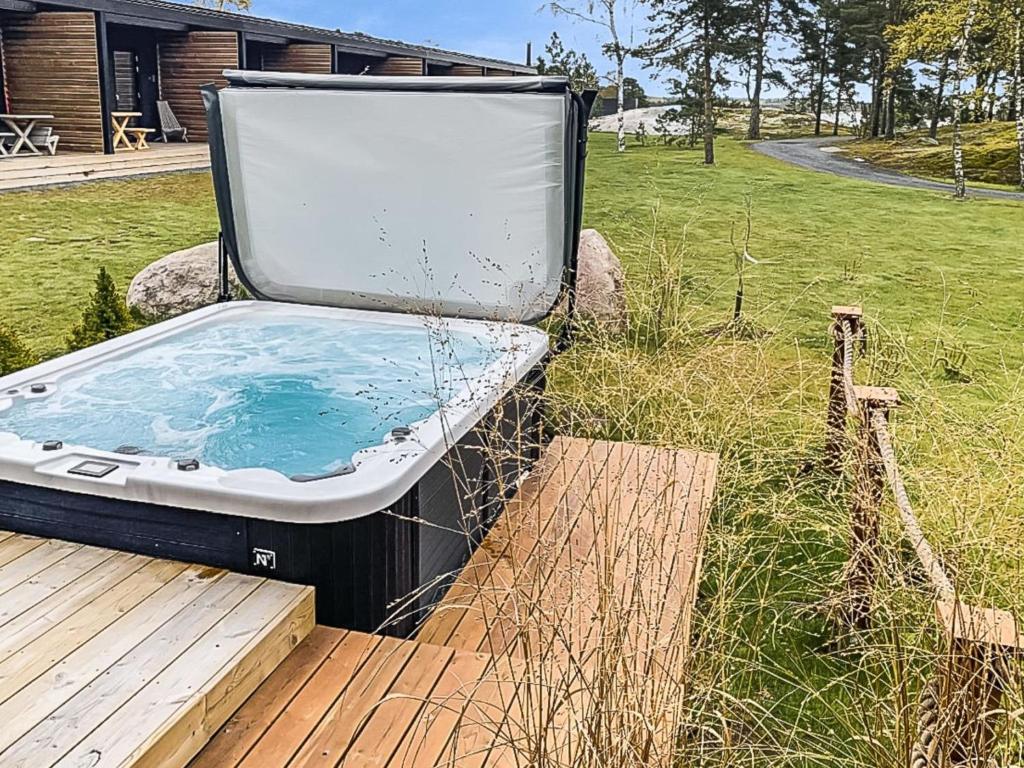 a hot tub sitting on top of a wooden deck at Holiday Home Kasnäs marina a 7 by Interhome in Kasnäs
