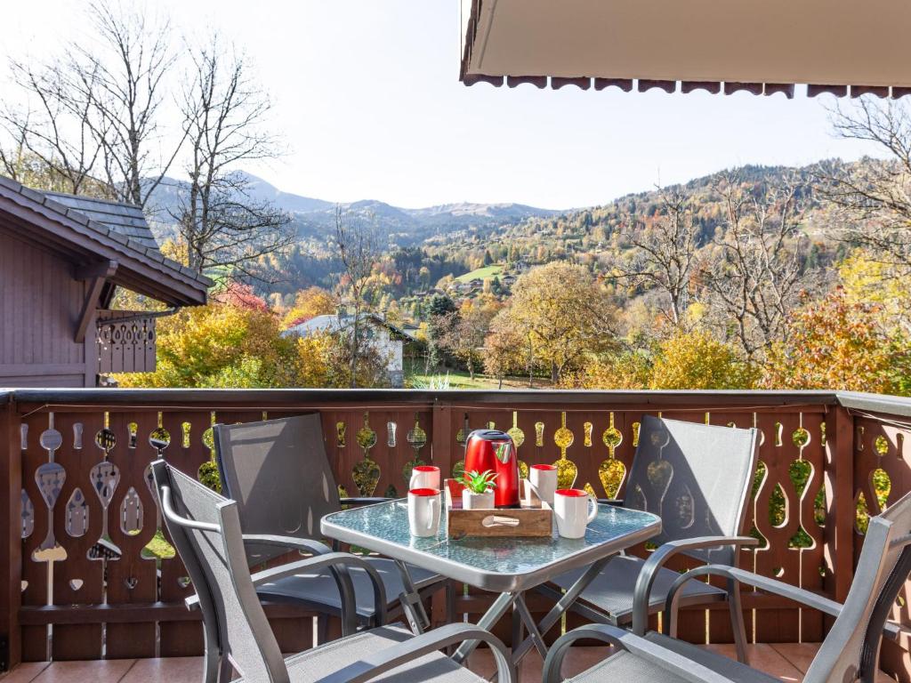 a table and chairs on a balcony with a view at Apartment les Huskies by Interhome in Saint-Gervais-les-Bains
