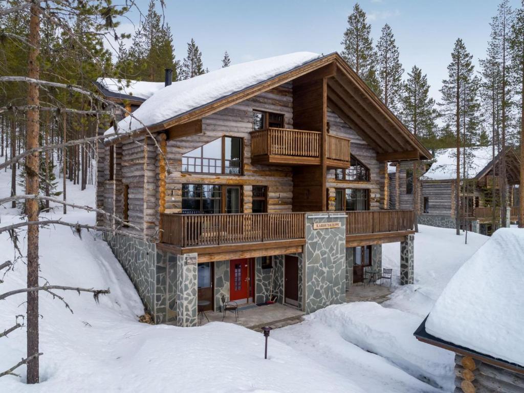a log cabin in the woods in the snow at Holiday Home Karhunkieppi 9b- 2 skipasses included by Interhome in Levi
