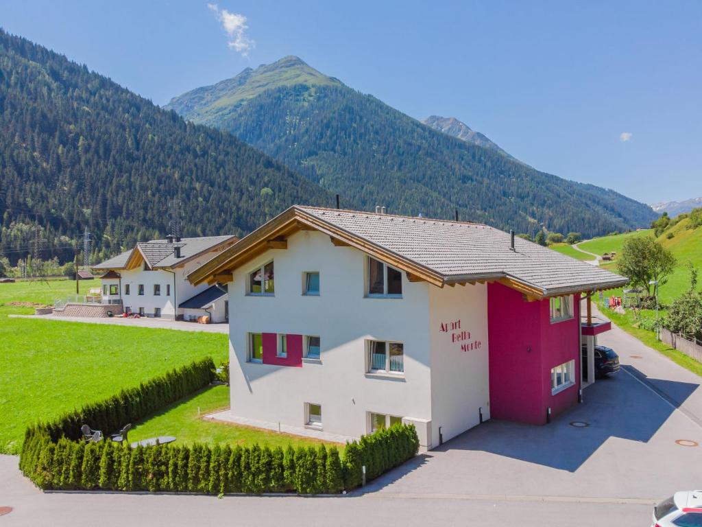 a house with a mountain in the background at Apartment Bella Monte-4 by Interhome in Pettneu am Arlberg