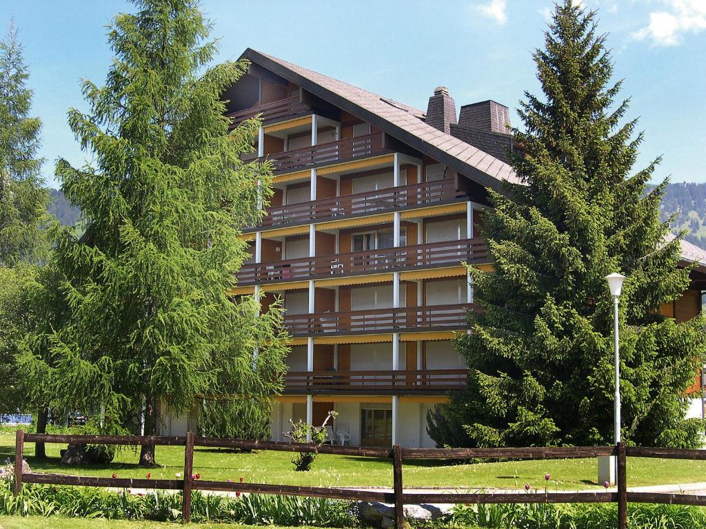 a large building with trees in front of it at Apartment Grenat 8 by Interhome in Villars-sur-Ollon
