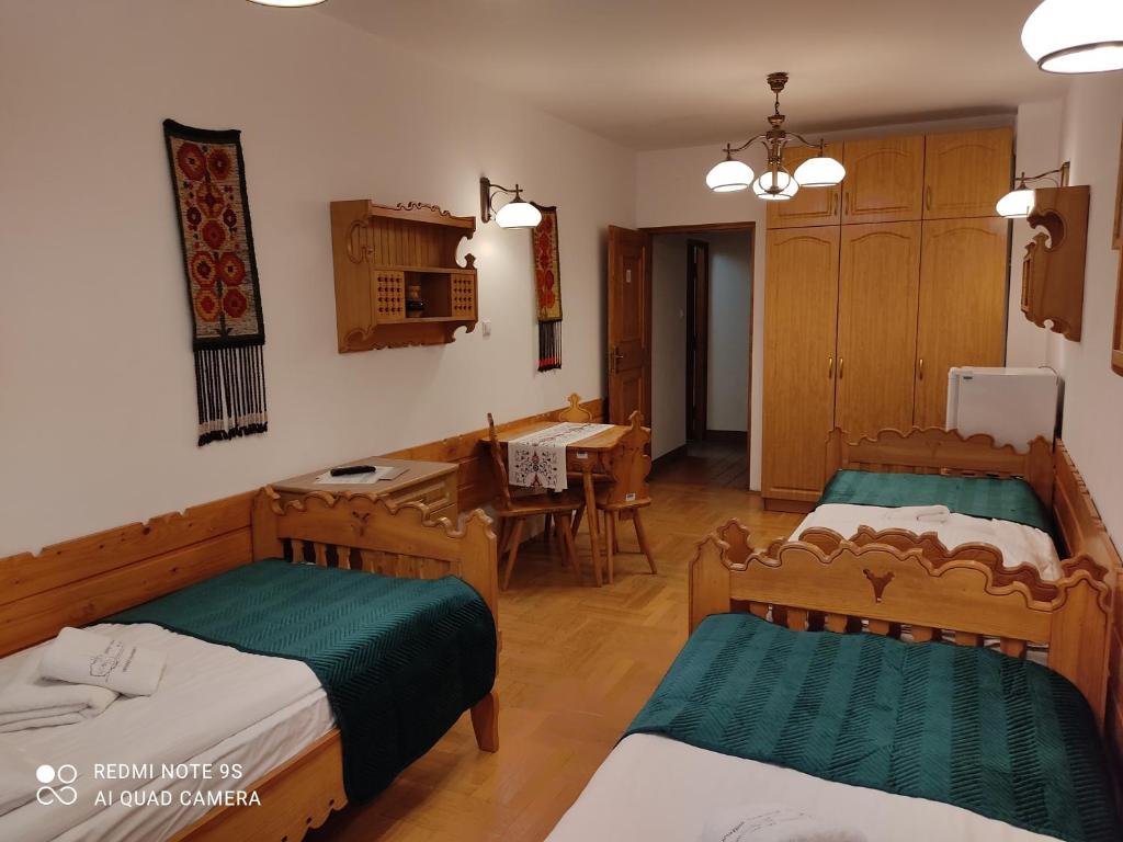 Posteľ alebo postele v izbe v ubytovaní Pokoje Gościnne Zakopane