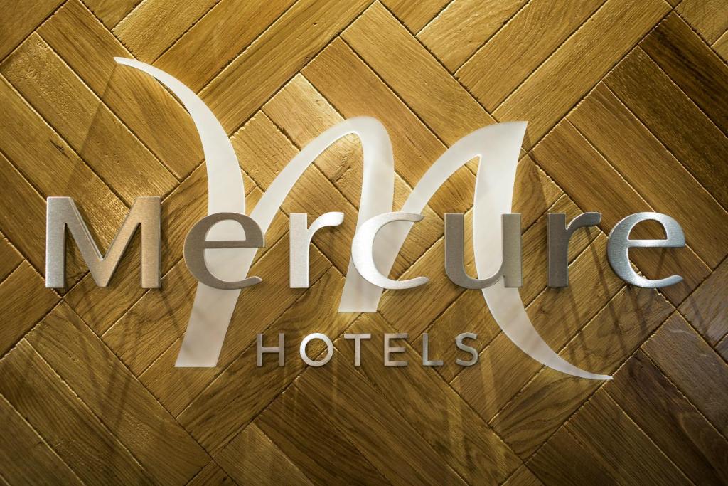 a sign for mercy hotels on a wooden floor at Mercure Doncaster Centre Danum Hotel in Doncaster