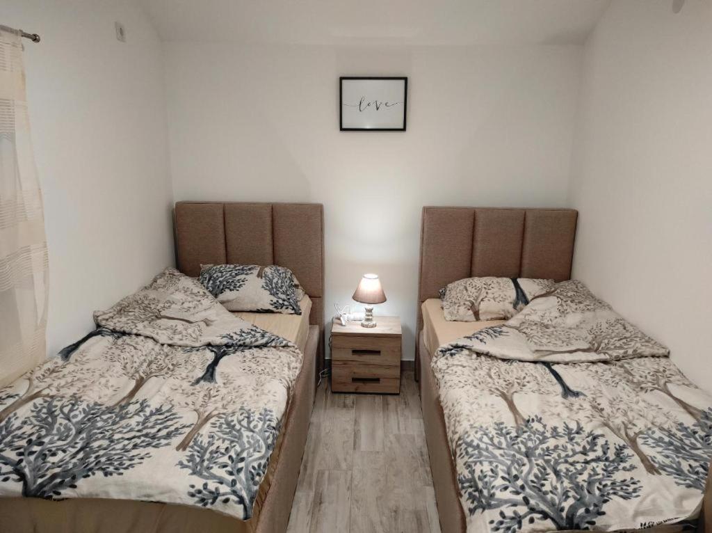 two beds sitting next to each other in a room at Vila Lake Krupac in Nikšić