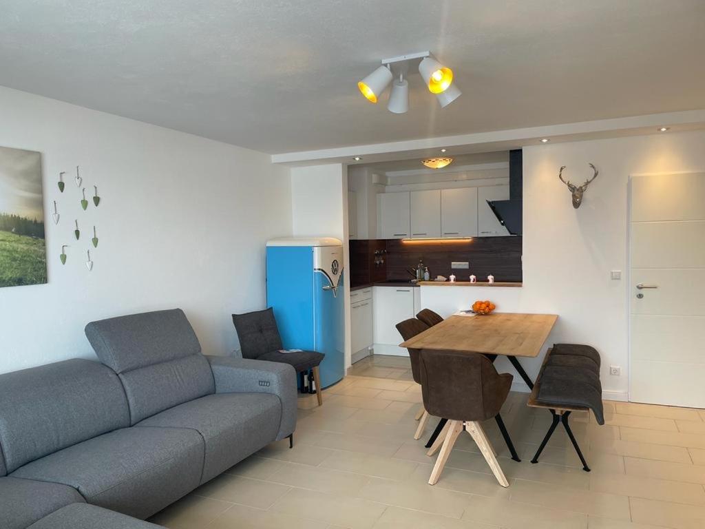 sala de estar con sofá y mesa en Ferienwohnung Oberallgäu Ferienpark mit Schwimmbad en Missen-Wilhams