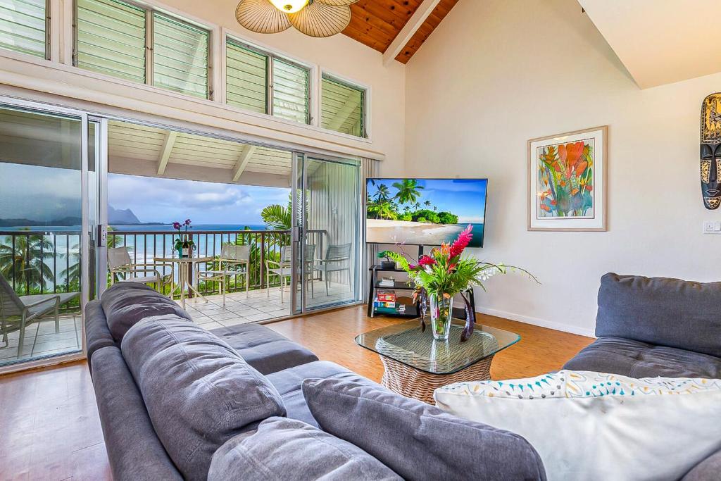 a living room with a couch and a tv at Pali Ke Kua #215 in Princeville