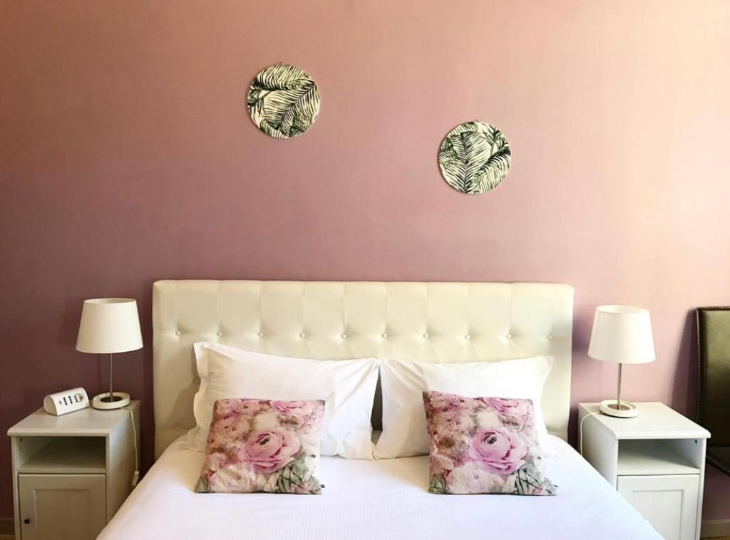 a bedroom with a bed with two pillows on it at Residenza Quaggio Ca' Grimani in Venice