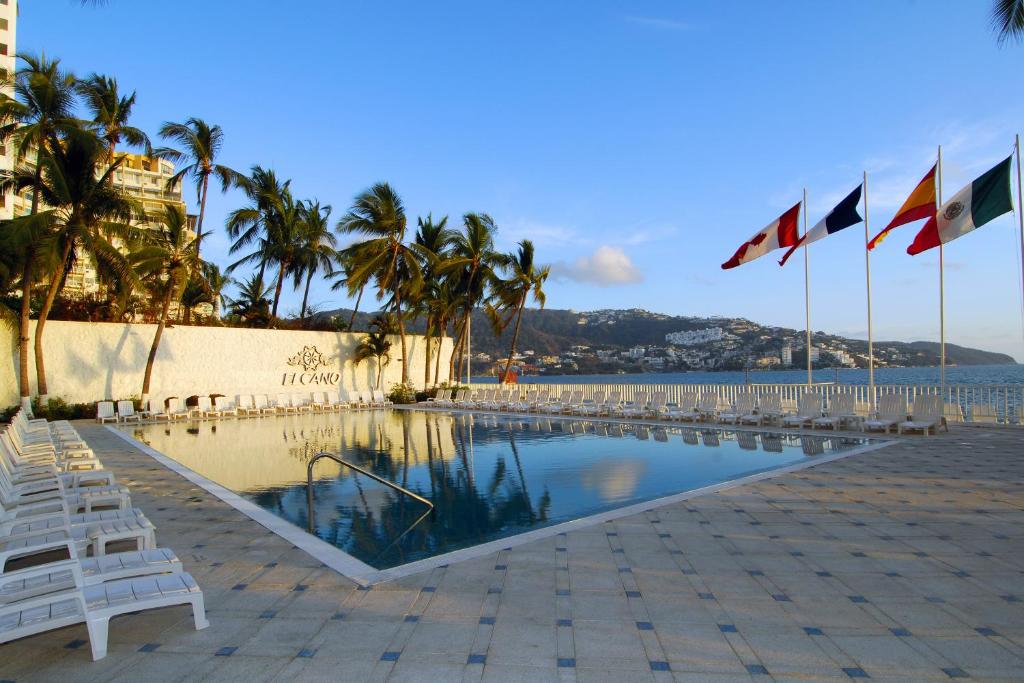 a man sitting in front of a pool of water at Hotel Elcano in Acapulco