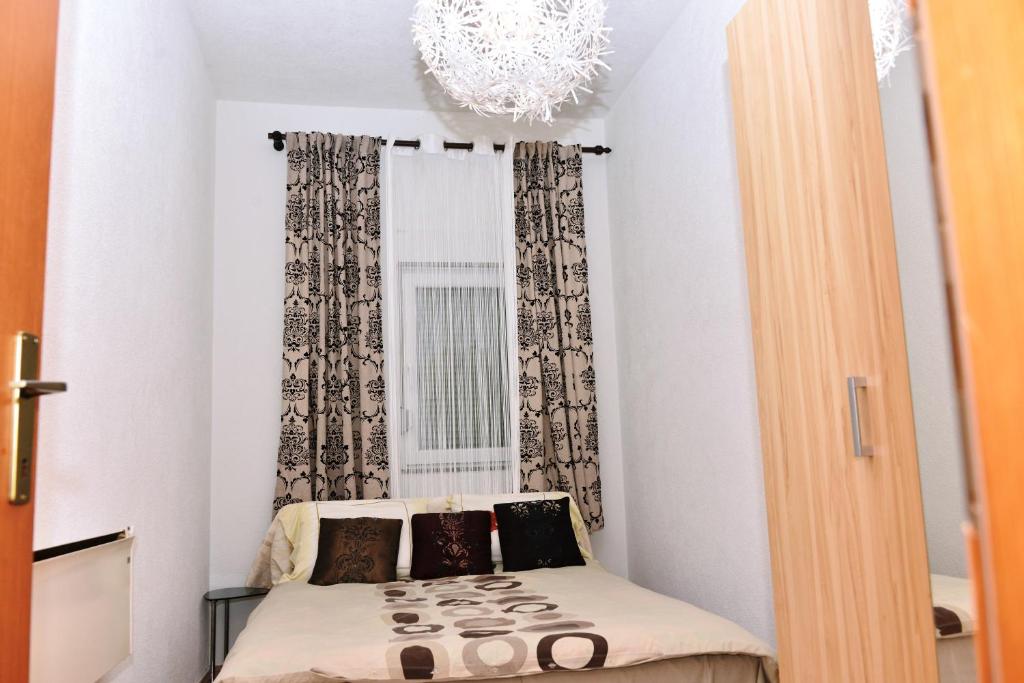 Kleines Zimmer mit einem Bett vor einem Fenster in der Unterkunft Apartman centar blizina Kastela i Splava in Banja Luka