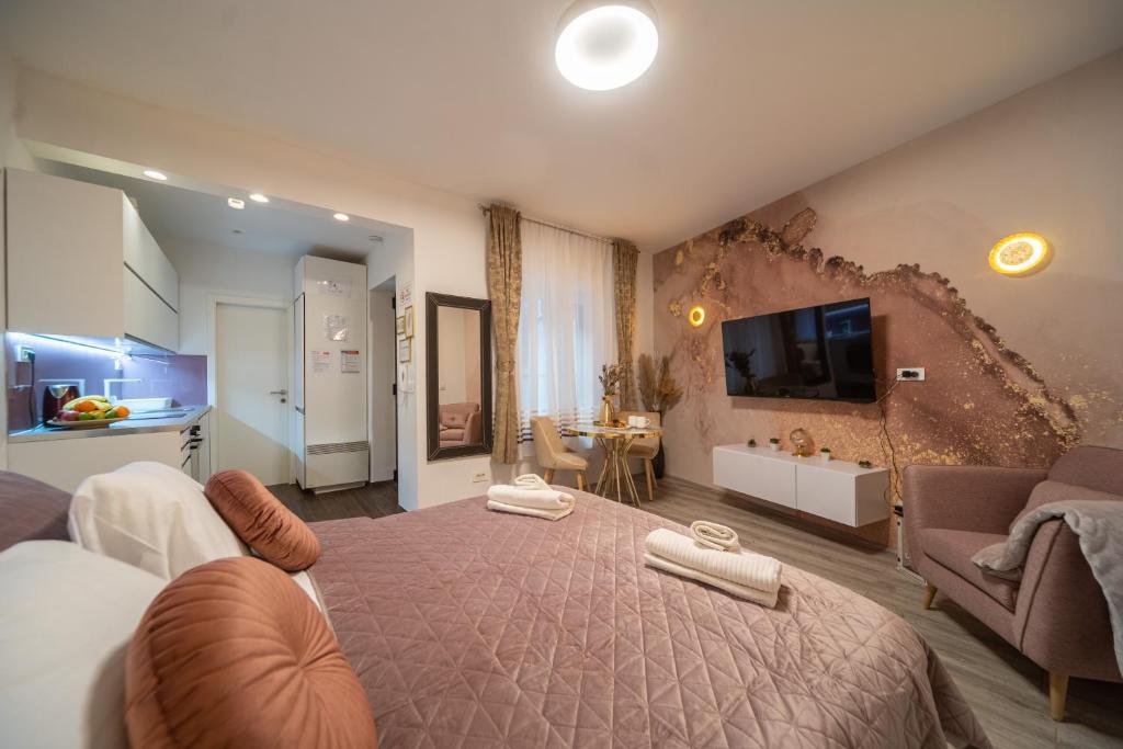 a bedroom with a large bed and a living room at Cosy&Private,30sec walk to MainSquare, Heart of Zagreb in Zagreb