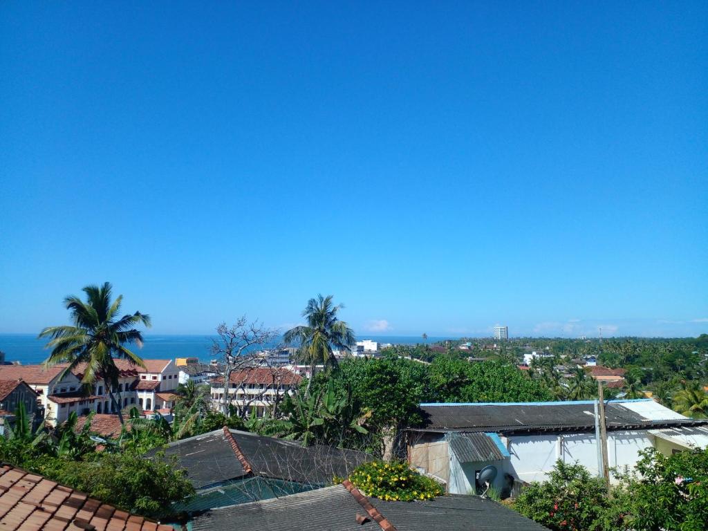 a view of a city with palm trees and the ocean at Galle City Nest in Galle