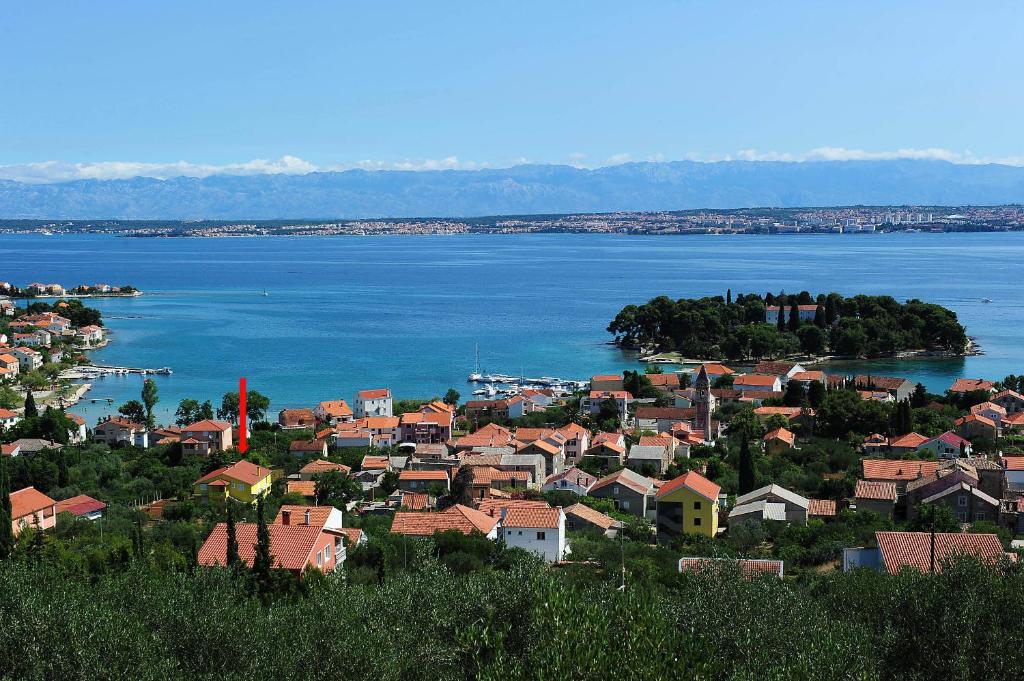 a town on the shore of a large body of water at Rooms Mediterranean Gardens in Preko