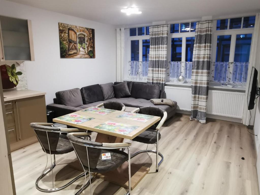 a living room with a couch and a table and chairs at Ferienwohnung Northeim City in Northeim