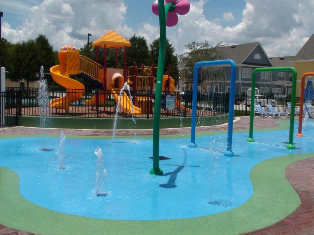 a water park with a playground with a water slide at Villas at Seven Dwarfs Lane Resort in Kissimmee