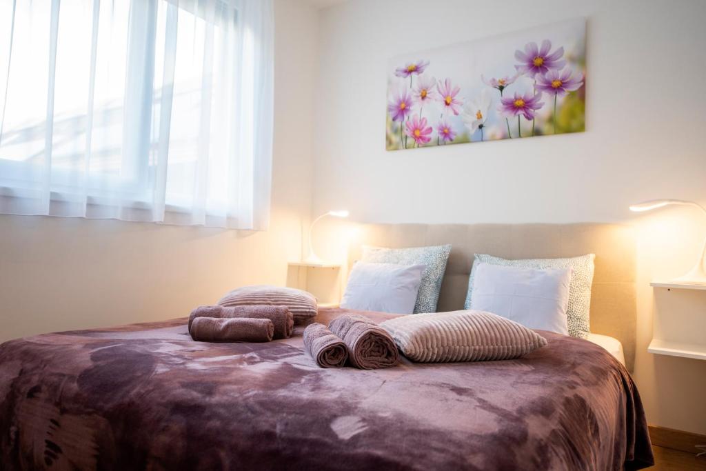 a bedroom with a bed with two pillows on it at Cute apartman- free parking in Pécs