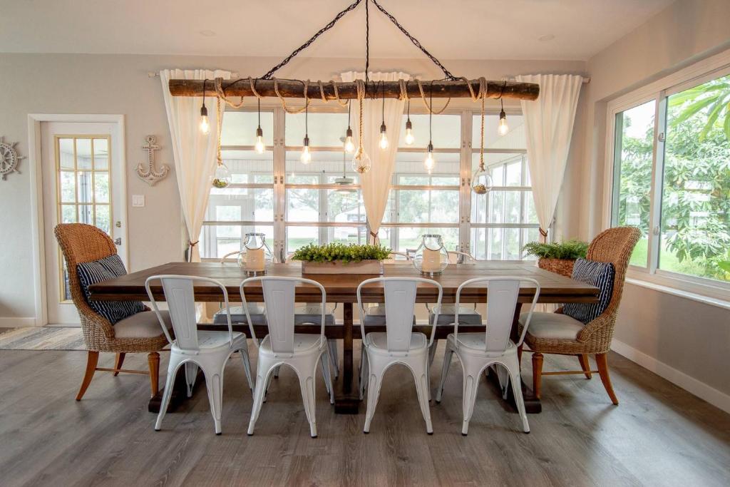 een eetkamer met een grote houten tafel en stoelen bij Sunrise on Lake Idylwild in Winter Haven