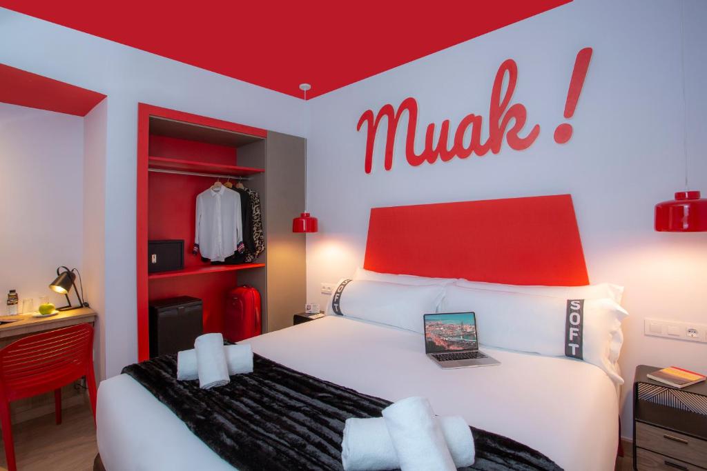 a bedroom with a large white bed with a red headboard at Casual Colours Barcelona in Barcelona