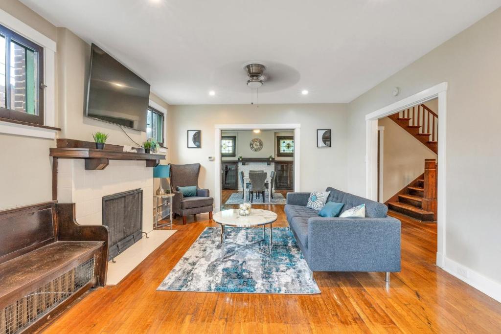 a living room with a couch and a fireplace at "NEW LISTING" Spacious 3 bedroom Large Home Close to Downtown, Oakland, & East Liberty! home in Pittsburgh