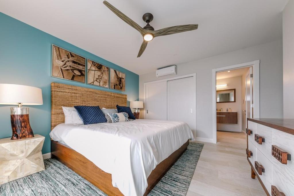 a bedroom with a bed and a ceiling fan at Grenada Condo in Lower Woburn