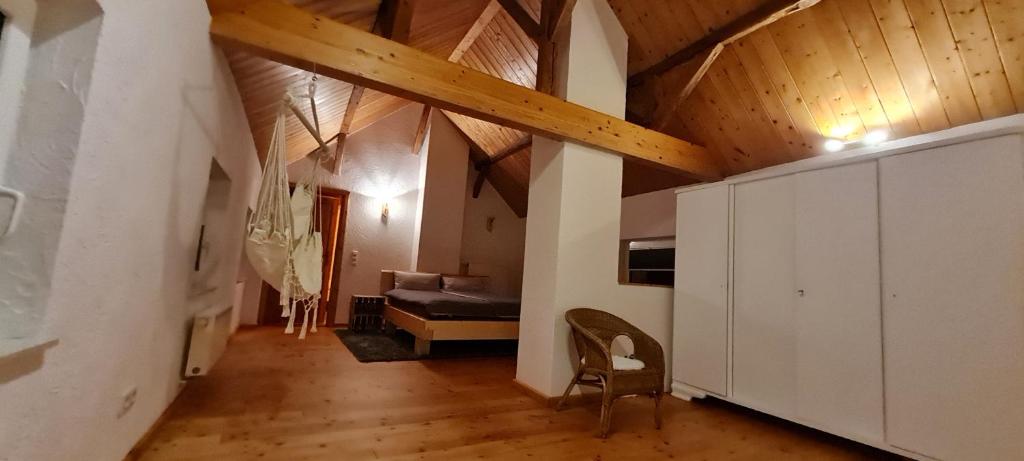 a living room with a wooden ceiling and a couch at Eifelhof mit Obstbaumwiese in Nideggen