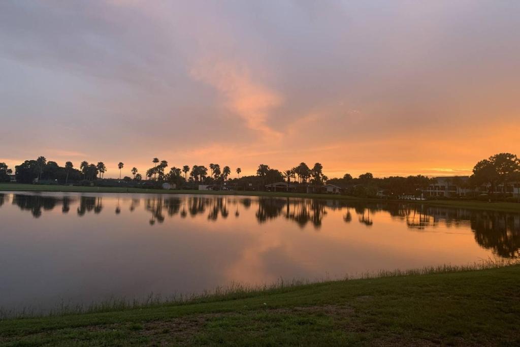 a large lake with a sunset in the background at Stunning Sunset Scenes in Wesley Chapel