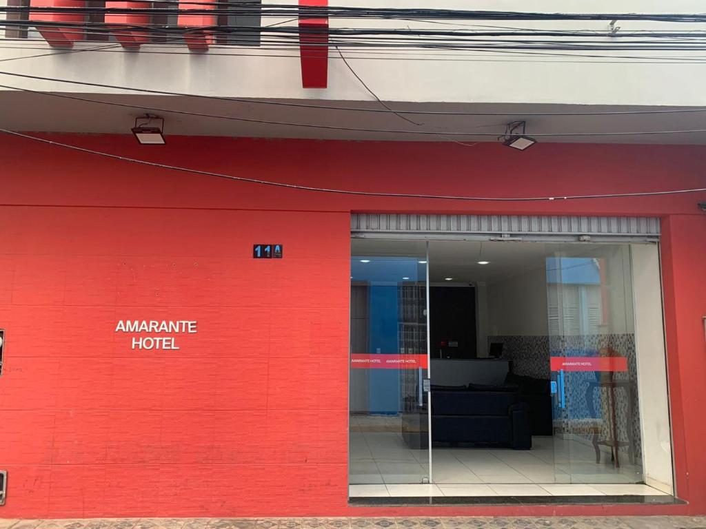 a red building with a red wall at Amarante Hotel in Juazeiro