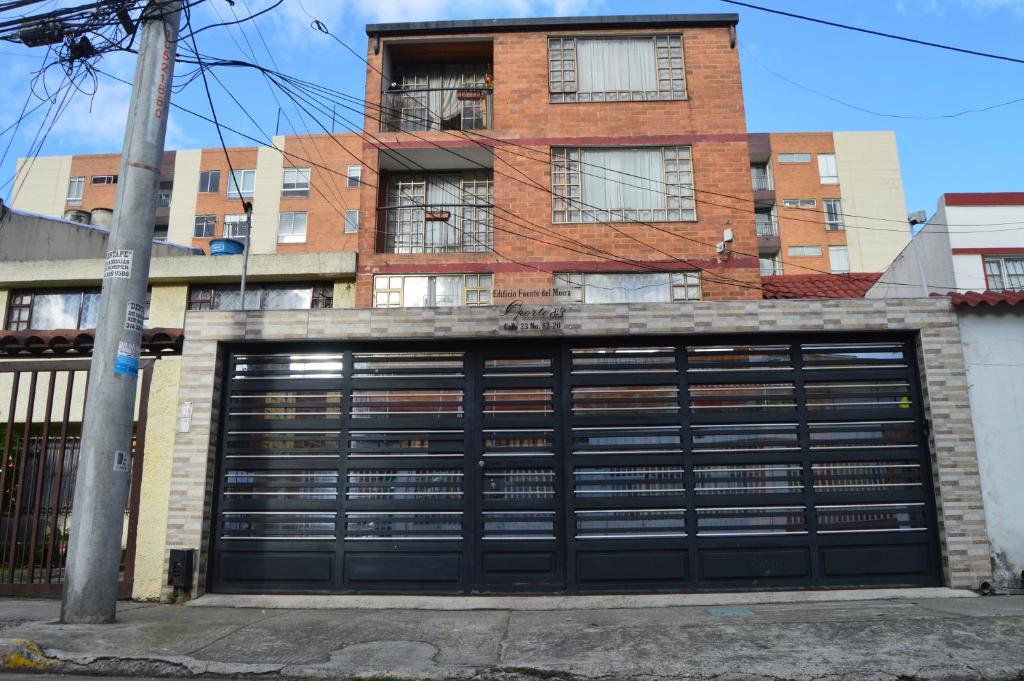 a garage door in front of a brick building at Oporto 83 in Bogotá