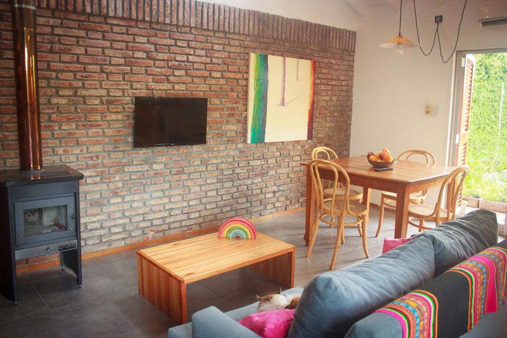 a living room with a couch and a brick wall at Cielo de Tierra in Coronel Suárez