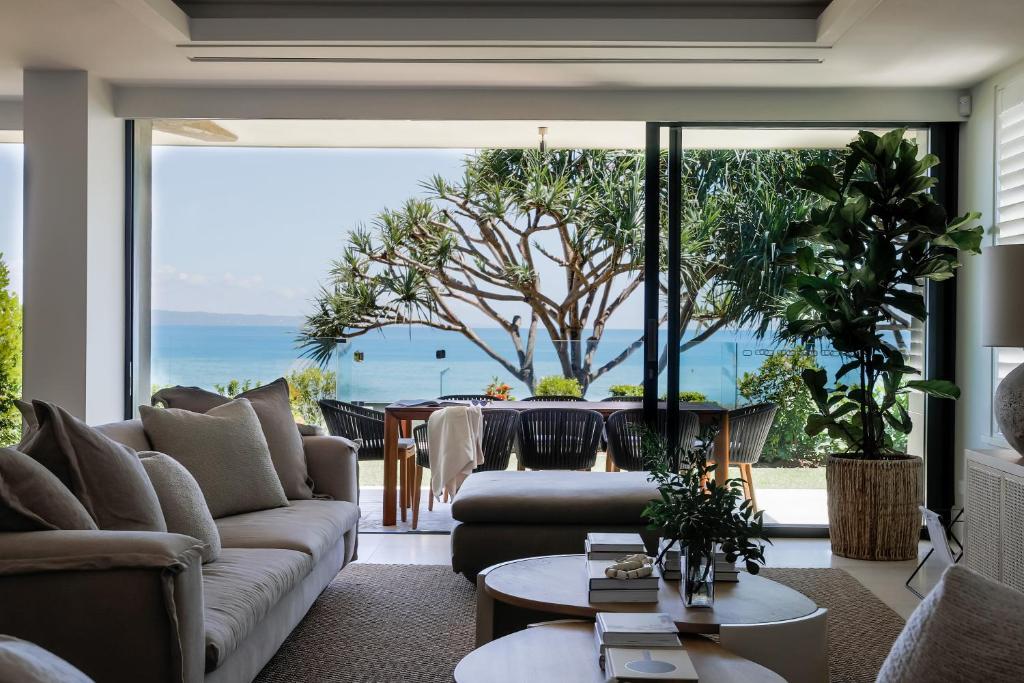 a living room with a view of the ocean at Noosa Court Apartment 4, Noosa Heads in Noosa Heads