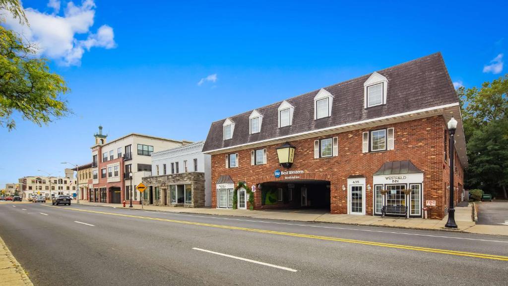 a large red brick building on a city street at The Westfield Inn, BW Signature Collection in Westfield